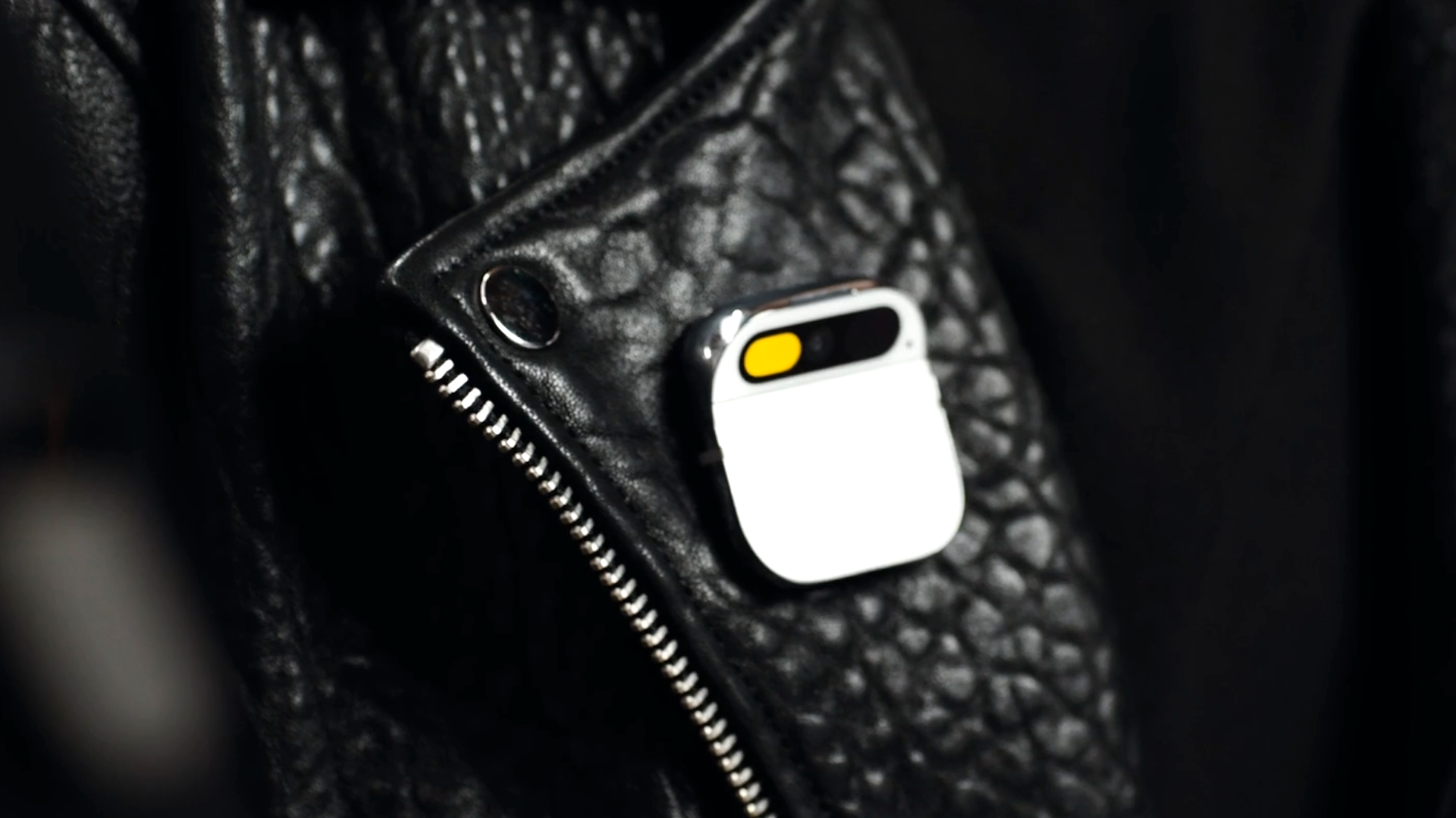 Humane's innovative AI-powered magnetic pin attached to a leather jacket